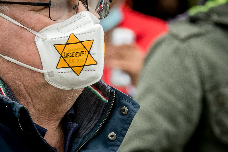Abbildung 6: Mensch mit FFP2-Maske mit der Aufschrift „Ungeimpft“und einem gelben Stern am 27.03 auf der Klardenken Demonstration in Ulm Quelle: Thomas Witzgall